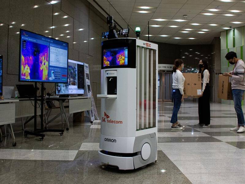A self-driving robot in South Korea checks visitors' temperatures and dispenses hand sanitiser.