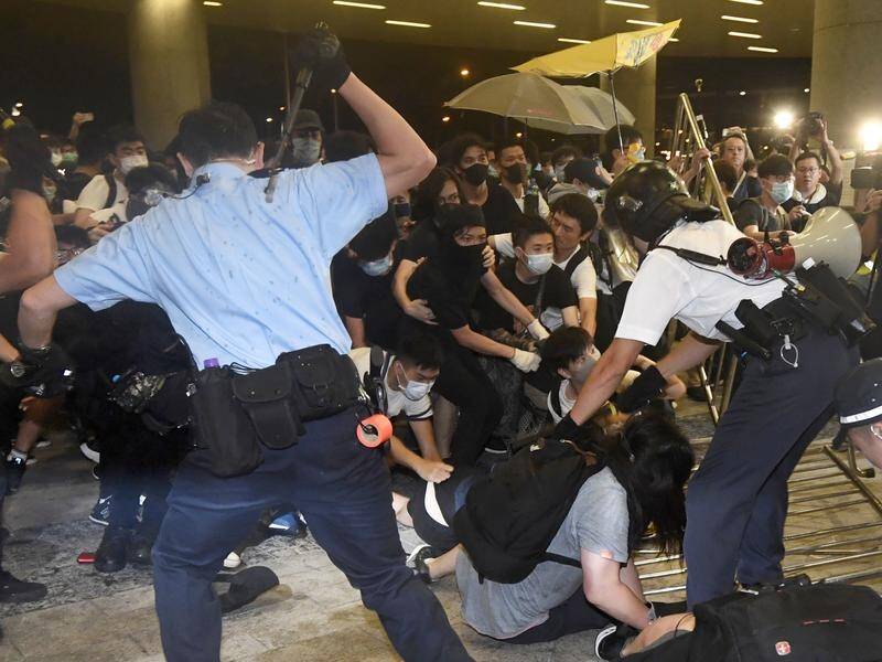 Police fought protesters outside Hong Kong's Legislative Council during an otherwise peaceful rally.