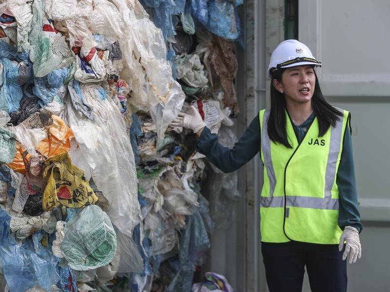 Malaysia's Minister of Environment Yeo Bee Yin shows plastic waste in a container.