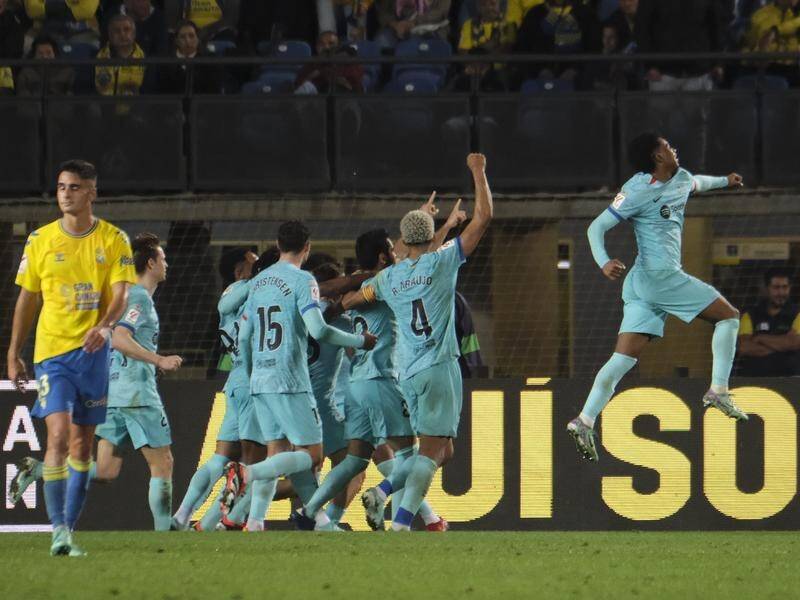 Barcelona celebrate their come-from-behind win over Las Palmas in the Spanish league. (EPA PHOTO)