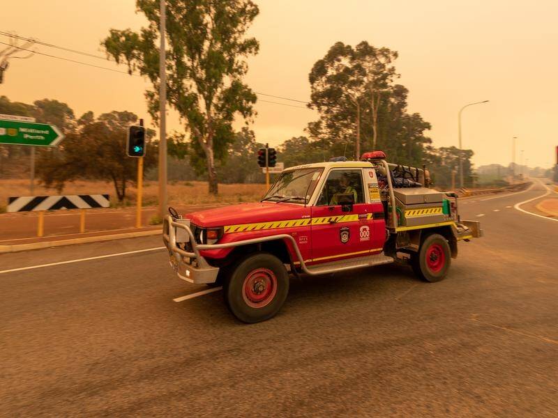 Nearly 60 homes have been destroyed by a large bushfire burning in Perth's northeast.