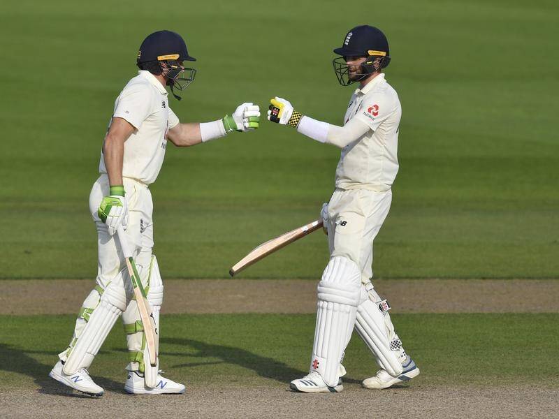 Jos Buttler, left, and Chris Woakes sealed a remarkable win for England over Pakistan on Saturday.