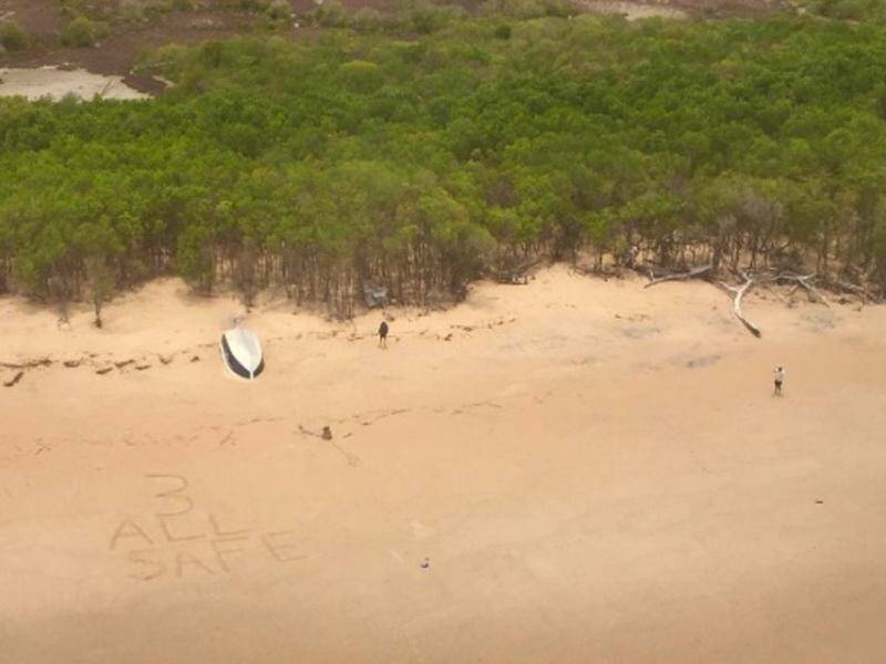 The fishermen wrote a message in the sand after their boat capsized in crocodile-infested waters.