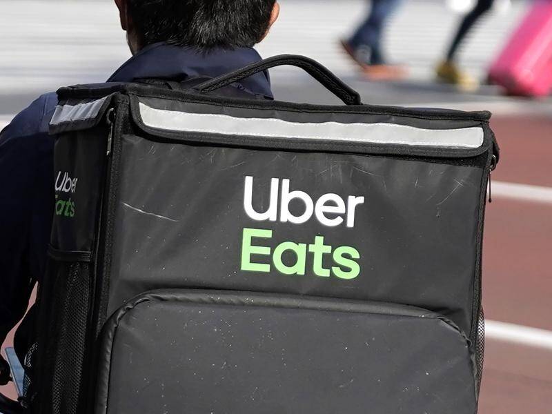 The families of two Uber Eats drivers killed in Sydney are seeking compensation over their deaths. (AP PHOTO)