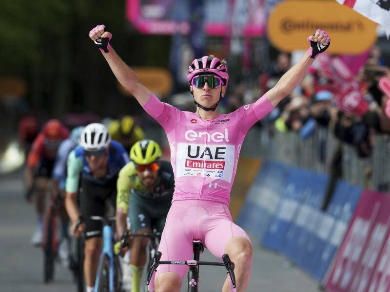 Tadej Pogacar celebrates his third win of the Giro d'Italia with Aussie Ben O'Connor (L) in third. (AP PHOTO)
