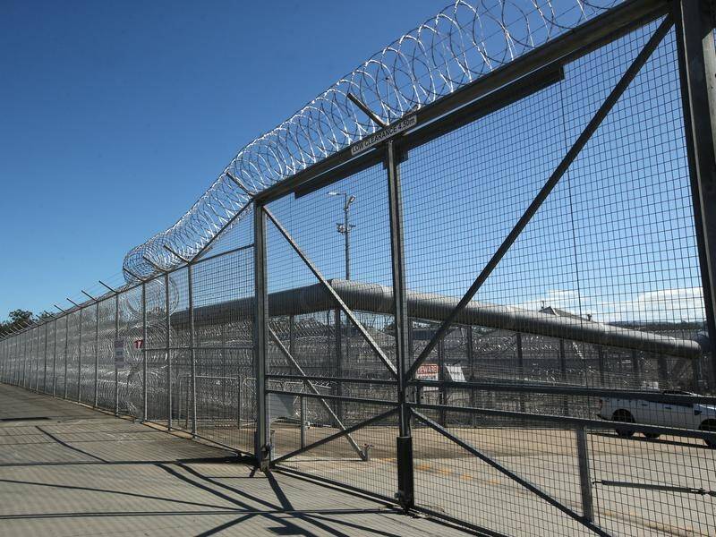 A woman was allegedly handcuffed and in leg irons during a 400km trip in the back of a prison van. (Jono Searle/AAP PHOTOS)