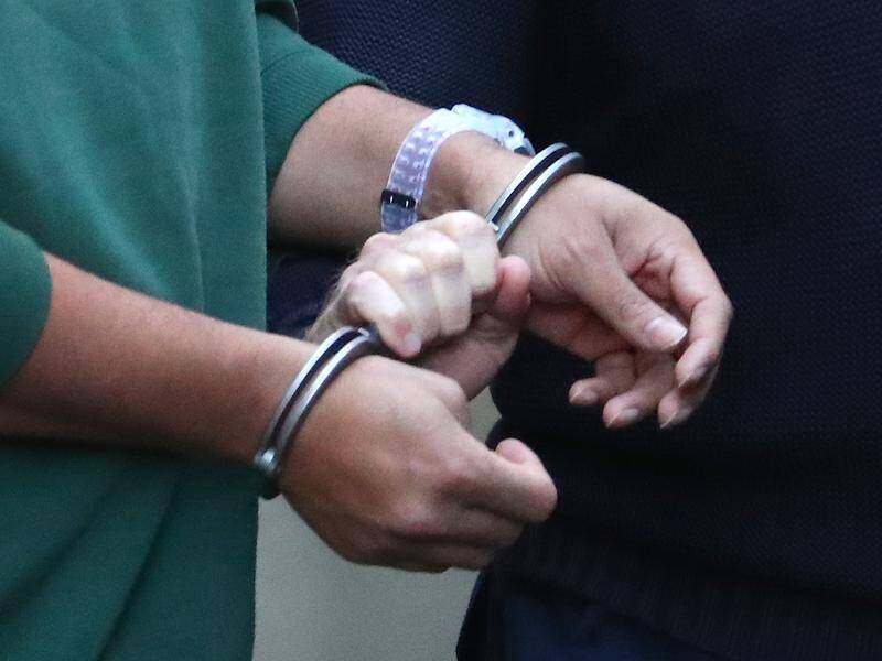 An asylum seeker has settled a case over being taken to medical appointments in handcuffs. (David Gray/AAP PHOTOS)