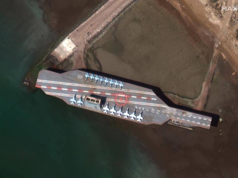 A mock aircraft carrier built by Iran has moved to the Strait of Hormuz.