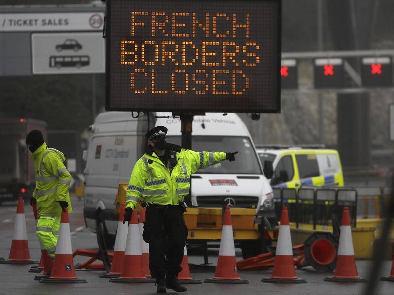 A police officer directs traffic at the entrance to the closed ferry terminal in Dover, England.