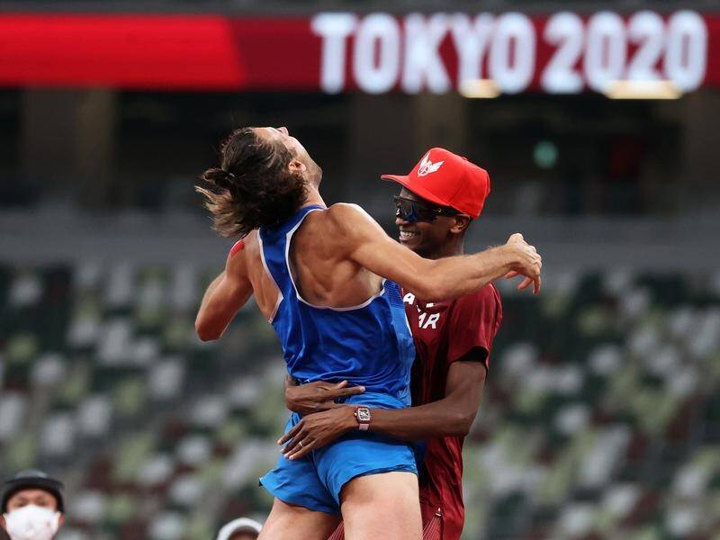 Gianmarco Tamberi (L) and Essa Mutaz Barshim hug after doing their deal to share high jump gold.