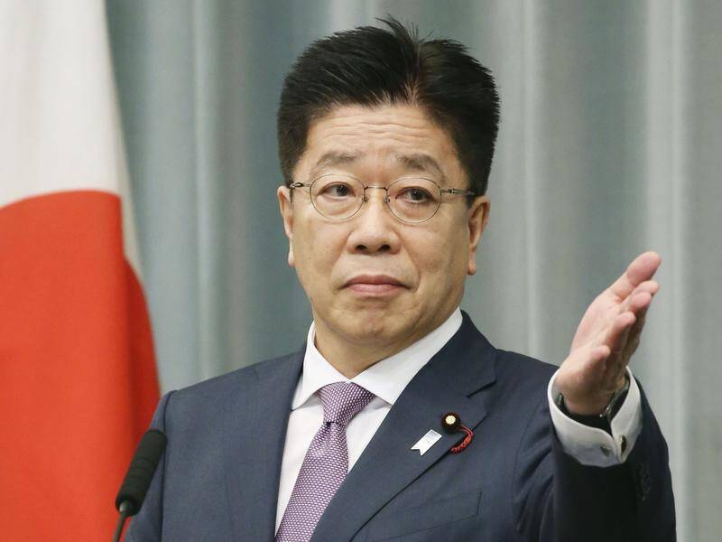 Chief Cabinet Secretary Katsunobu Kato says Tokyo has asked Beijing to stop anal swabs on Japanese.