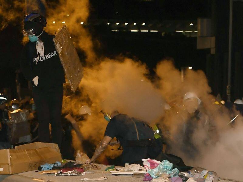 Hong Kong police fired tear gas at protesters after they stormed the legislature and trashed it.