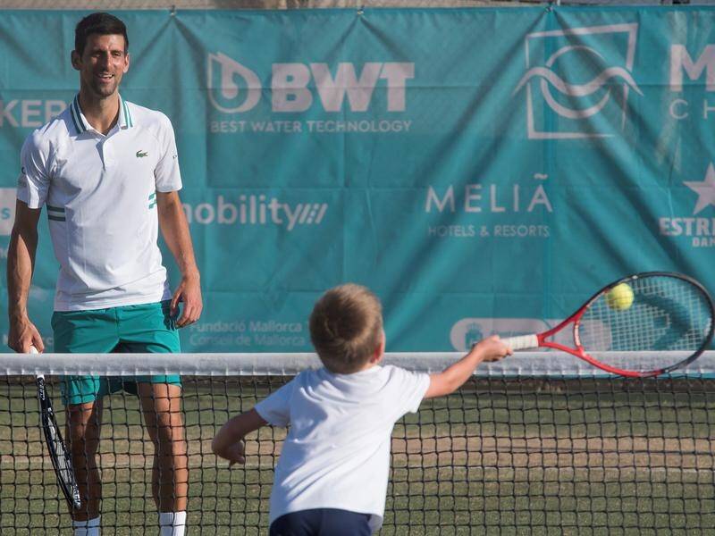 Novak Djokovic hitting with his son Stefan in 2021.