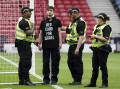 Police with a protester who had chained himself to a goalpost before Scotland's match with Israel. (AP PHOTO)