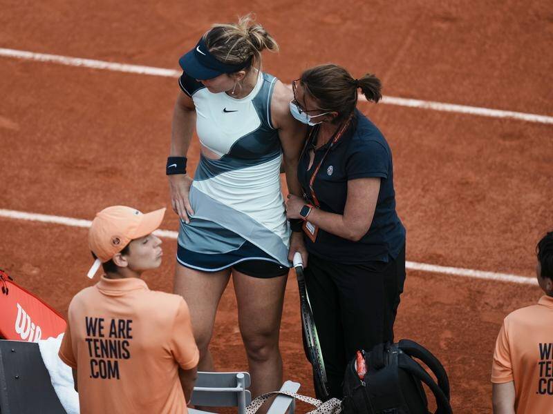 Spain's Paula Badosa receives medical assistance prior to retiring against Veronika Kudermetova.