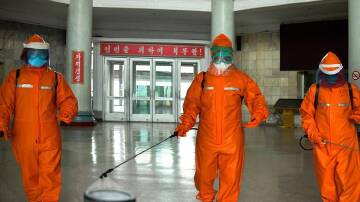 Staff disinfect Pyongyang station in a campaign to curb a COVID-19 outbreak in North Korea.