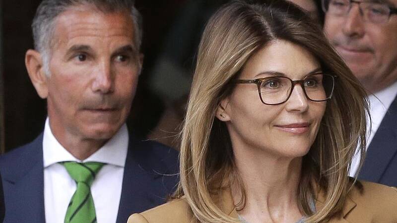 Lori Loughlin and her husband (L) are facing more charges along with 15 others over a college scam.