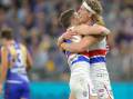Aaron Naughton (r) kicked four goals in the Bulldogs' 101-point thrashing of West Coast in Perth.
