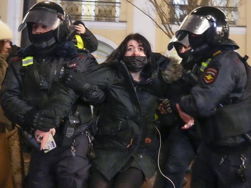 Russian police detain an anti-war protester in St Petersburg.