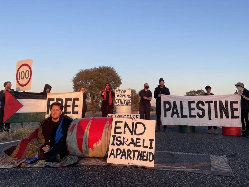 A small group of protesters gathered on Hatt Road near Pine Gap from dawn to before 10am on Friday. (HANDOUT/MPARNTWE FOR PALESTINE)