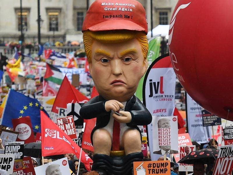 Protesters rallied around a giant effigy showing Donald Trump tweeting while sitting on a toilet.