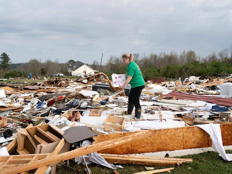 Rebecca Haynes Griffis surveys the debris after tornadoes struck Ohatchee, Alabama.
