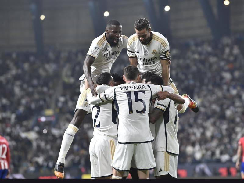 Real Madrid celebrate a goal in their Spanish Super Cup semi-final win over Atletico Madrid. (AP PHOTO)