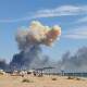 Smoke rises over the beach at Saky following blasts at the nearby Russian military air base. (AP PHOTO)