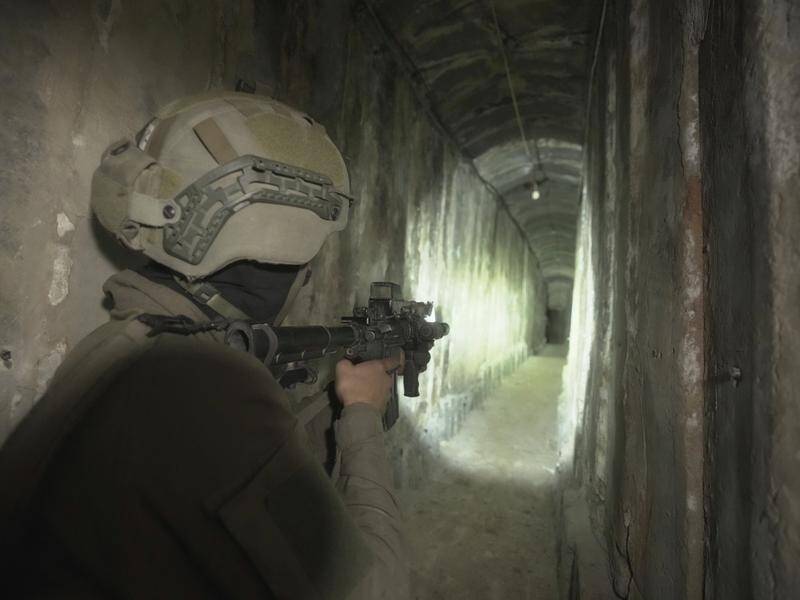 An Israeli soldier shows media an underground tunnel found underneath Shifa Hospital in Gaza City. (AP PHOTO)