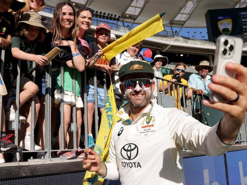 Nathan Lyon takes selfies with the fans after his landmark achievement of taking 500 Test wickets. (Richard Wainwright/AAP PHOTOS)