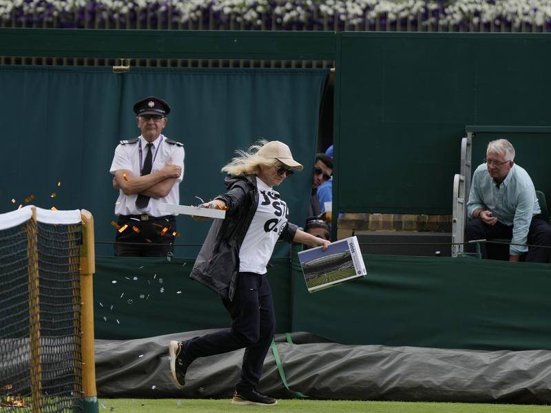 A Just Stop Oil protester runs onto court and interrupts a match by releasing confetti at Wimbledon. (AP PHOTO)