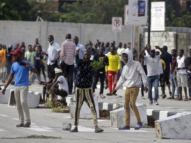 Protesters gathered at a Lagos toll gate that was the scene of violence the night before.