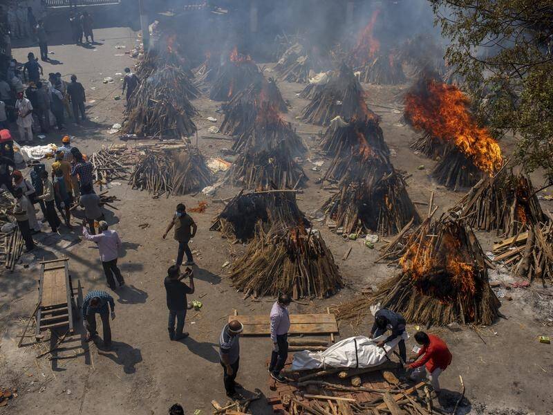 Multiple funeral pyres of COVID victims burn at a ground converted into a crematorium in New Delhi.