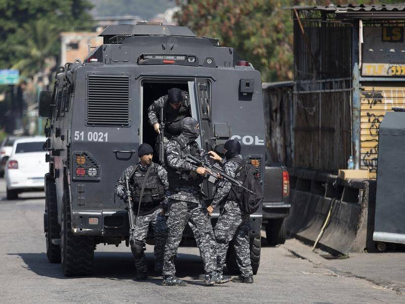 Suspects tried to flee over rooftops as police arrived in armoured vehicles in the Jacarezinho slum.