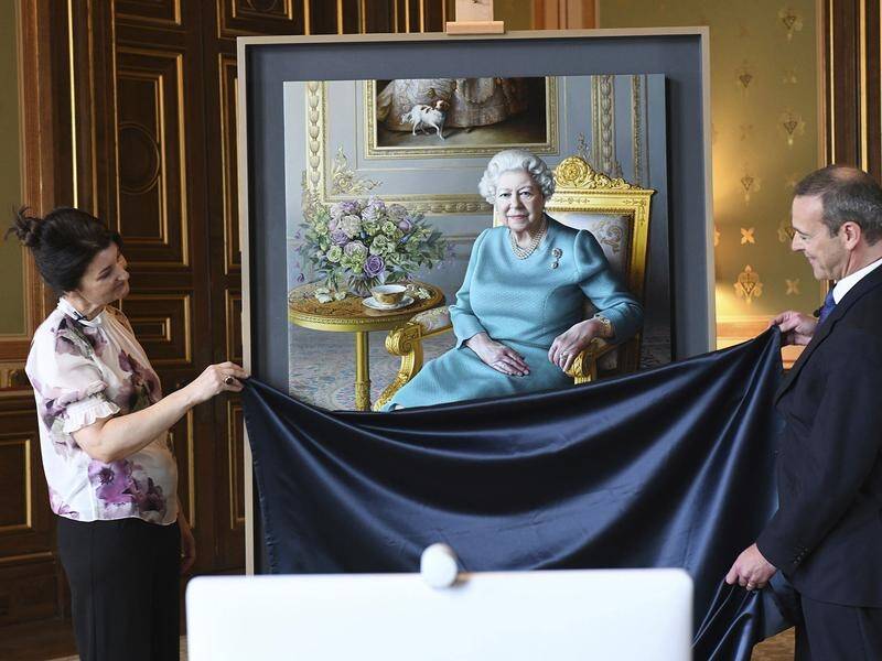 A new portrait of the Queen shows her wearing a blue dress, pearls and low-heeled black shoes.