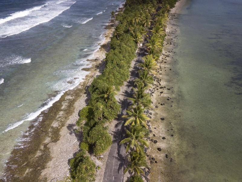 Waters near a road on Funafuti in the South Pacific, which has been affected by climate change. (Mick Tsikas/AAP PHOTOS)