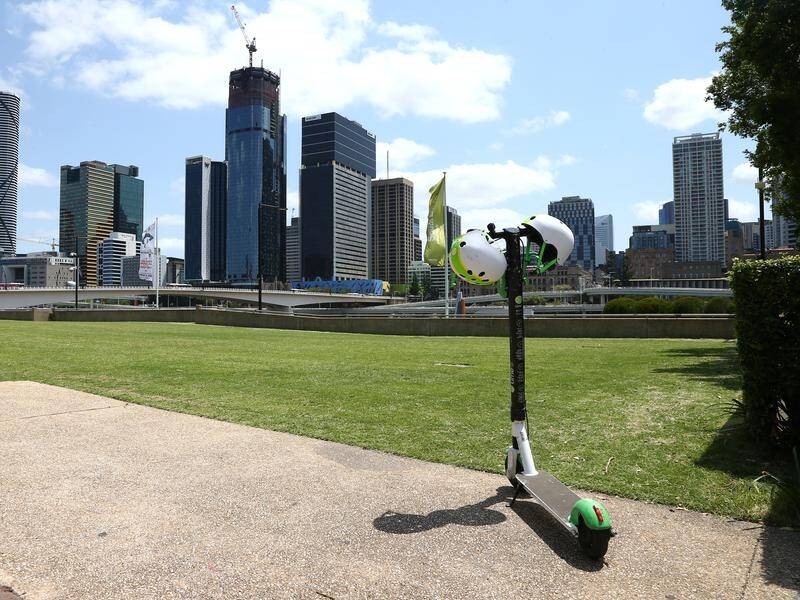 A man has died after falling off an electric-scooter and hitting his head in Brisbane. (David Clark/AAP PHOTOS)