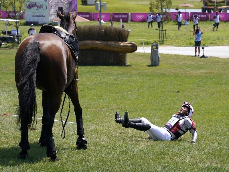 Japan's Yoshiaki Oiwa falls from his horse Calle 44 in the Olympic eventing cross county competition