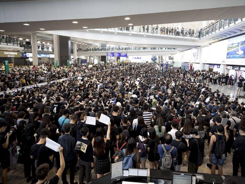 Protesters demonstrate at the airport in Hong Kong, prompting the suspension of check-ins..
