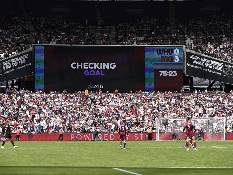 A screen displays a VAR check during the Premier League match between West Ham and Manchester City.
