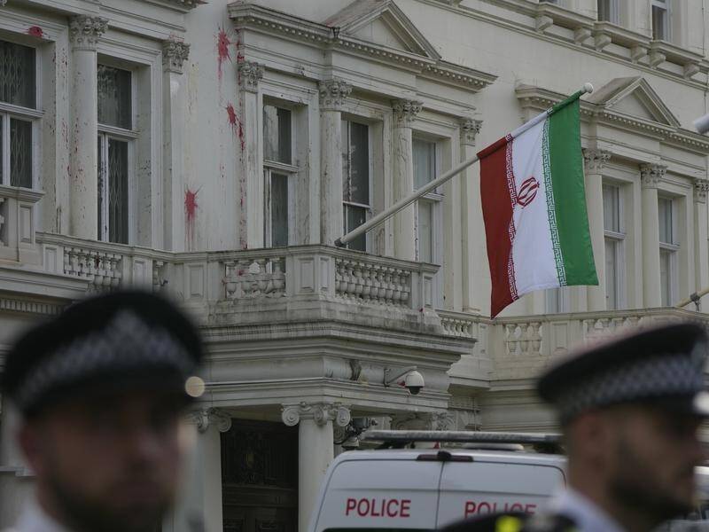 Police say officers were injured in skirmishes outside the Iranian embassy compound in London. (AP PHOTO)
