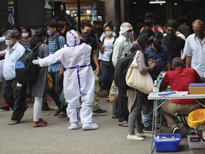 Passengers get tested for COVID-19 outside a train station in Bengaluru, India.