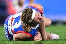 Western Bulldogs forward Aaron Naughton was in agony after his knee injury in the loss to the Swans. (Joel Carrett/AAP PHOTOS)