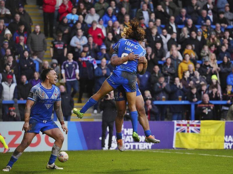 Samoa celebrate after Brian To'o's try helped propel them to a World Cup win over Tonga. (AP PHOTO)