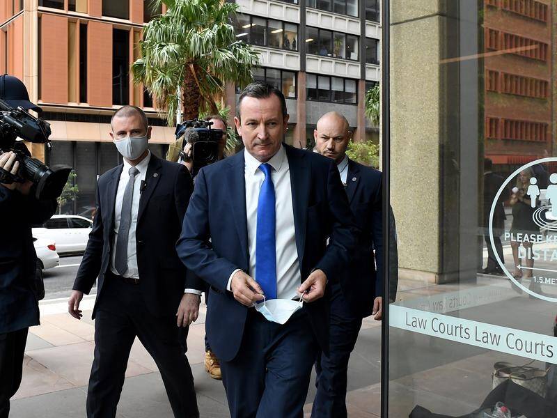 A verdict in the defamation case between Clive Palmer and Mark McGowan (centre) is due on Tuesday. (Bianca De Marchi/AAP PHOTOS)