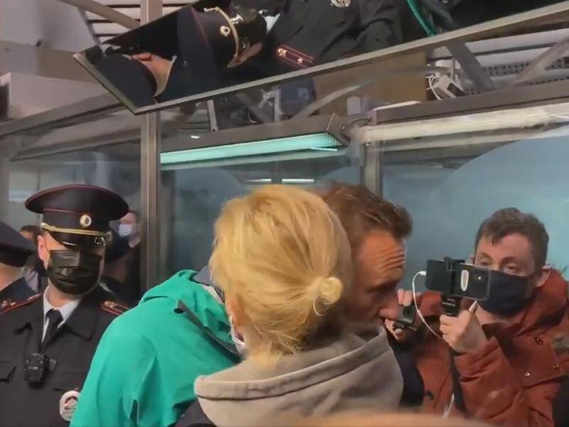 Russia's opposition leader Alexei Navalny embraces wife Yulia before his arrest in Moscow.