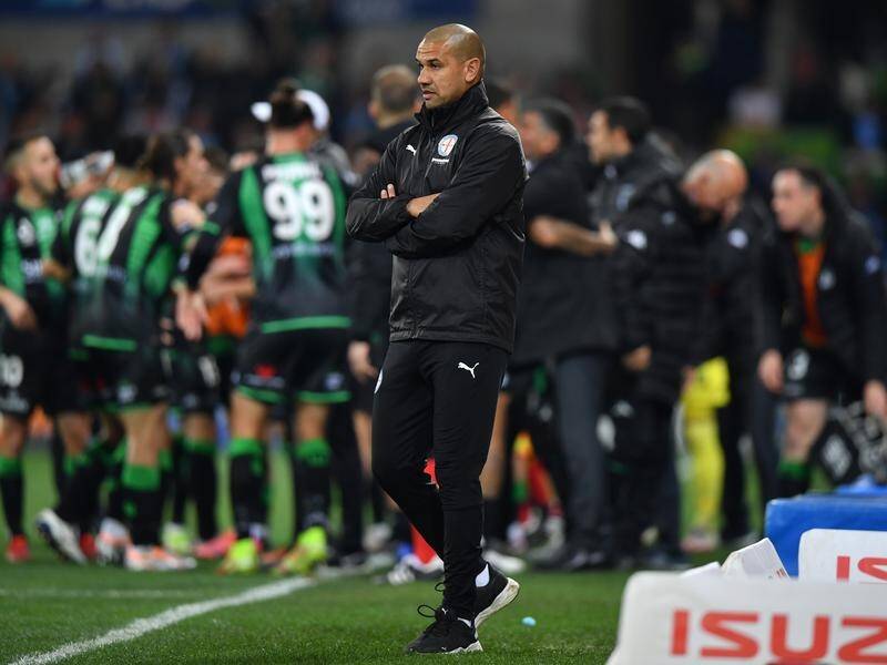 Melbourne City head coach Patrick Kisnorbo looks away as Western United players celebrate.