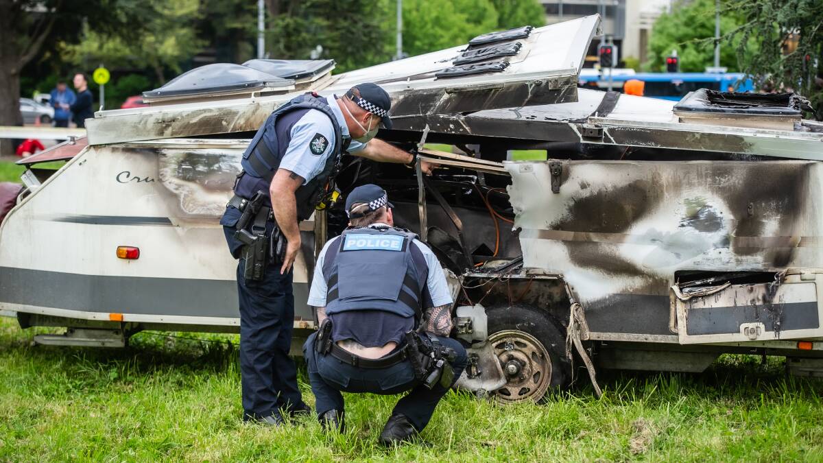 Police inspect the burned caravan. Picture by Karleen Minney 