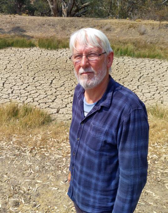 Vilnis Ozolins and the dam at his winery which has never dried up completely before. Picture: Steve Evans