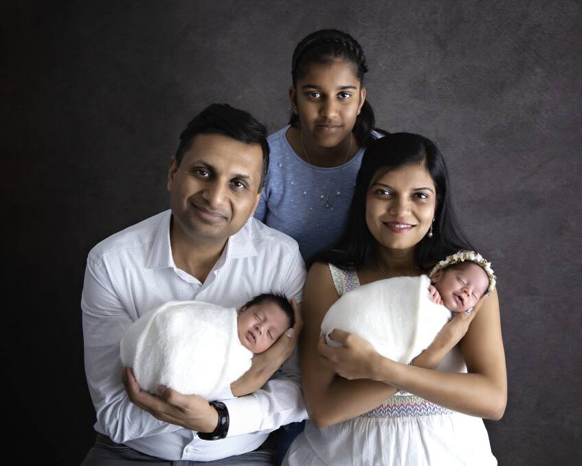 The complete family. (Back) Sanjana Jain. Namita Mittal (right) holding Antara and Tarun Jain (left) holding Arjun. 